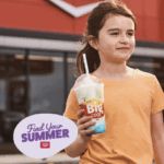 Photo of a young girl holding a Big Cool slushie, with the words "Find Your Summer"